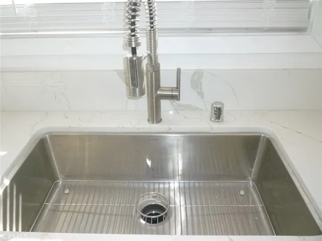 a kitchen with a sink and a stove top oven