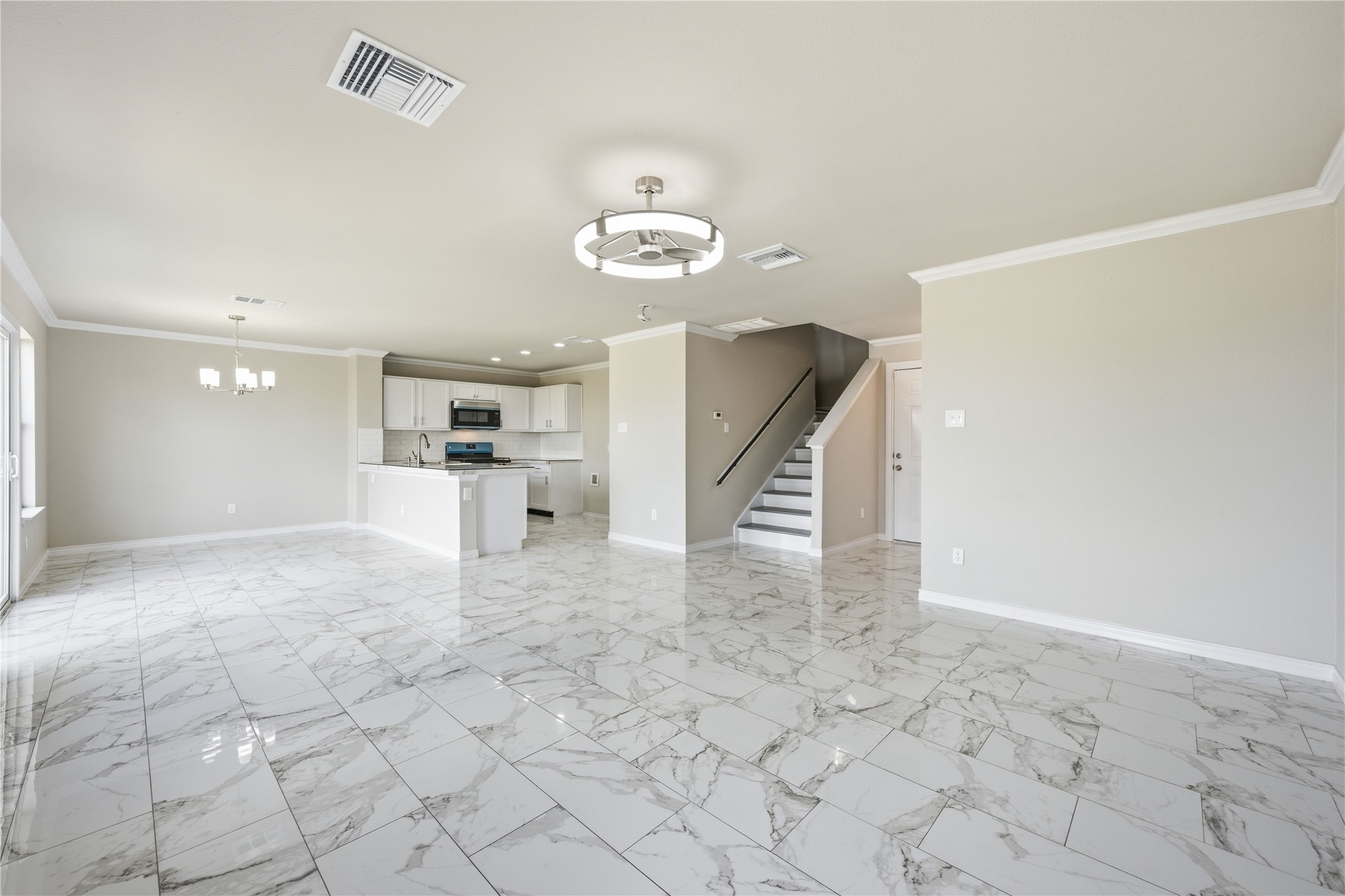 6917 Panda Royle Drive Del Valle, TX 78617 - Photo 5 of 23 A spacious, airy interior boasts elegant tile flooring and contemporary lighting.