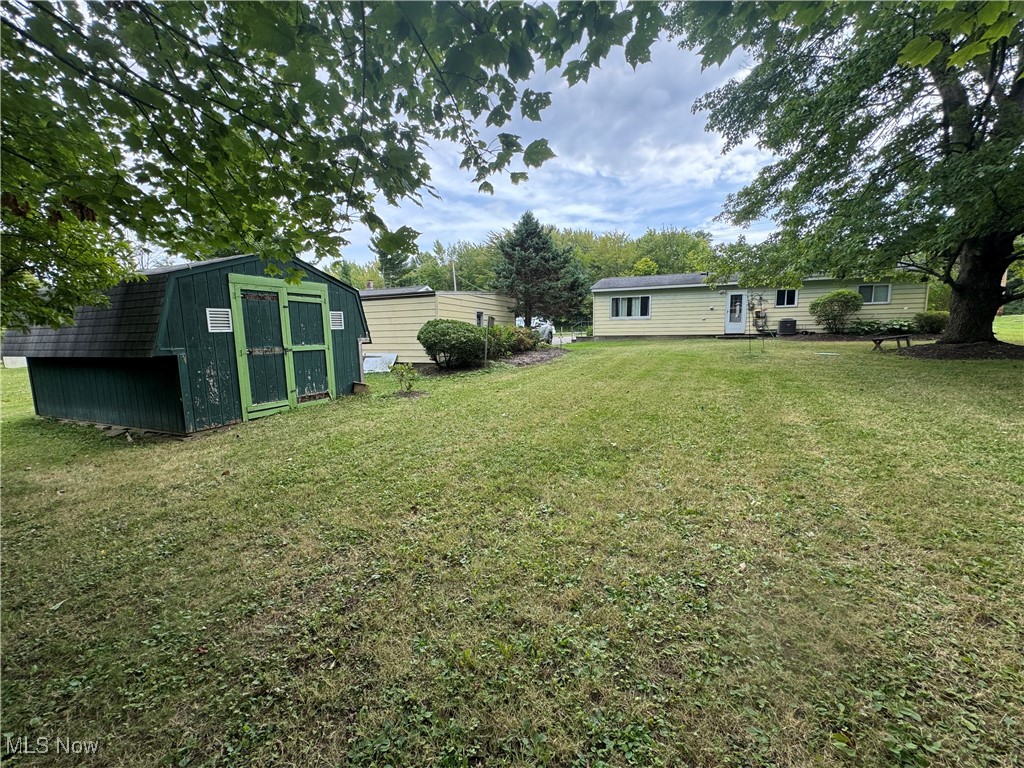 8810 Auburn Road Chardon, OH 44024 - Photo 20 of 22 View of grassy yard with a shed