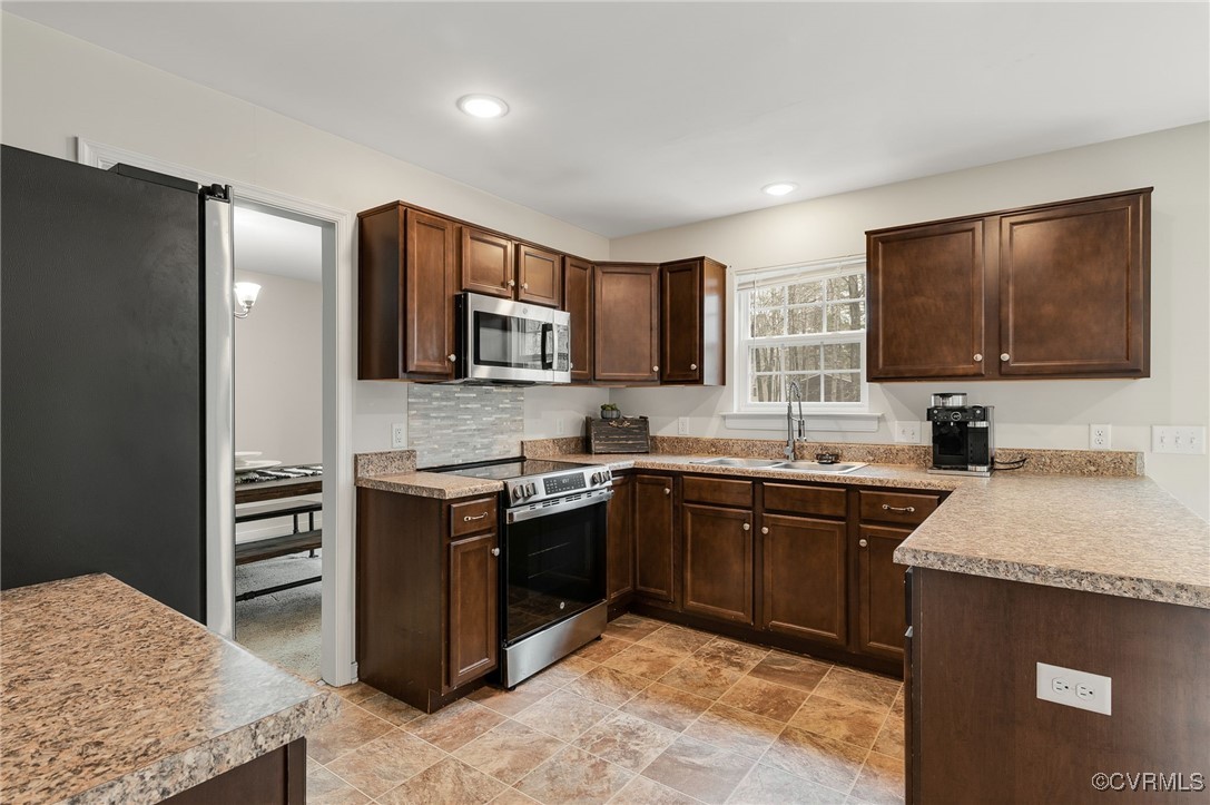 11 Haversack Road Palmyra, VA 22963 - Photo 3 of 32 a kitchen with stainless steel appliances granite countertop a stove top oven a sink dishwasher a refrigerator and a microwave oven with wooden floor