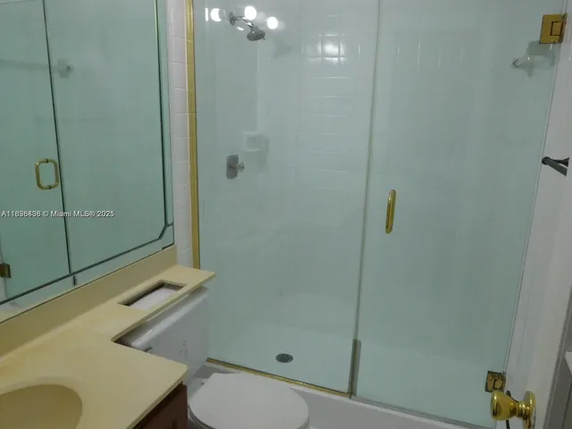 a bathroom with a shower a toilet and sink
