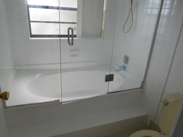 a bathroom with a shower and toilet