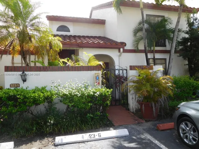 a view of a house with a yard and plants