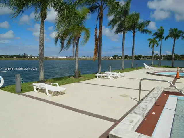 a view of swimming pool with a table and chairs