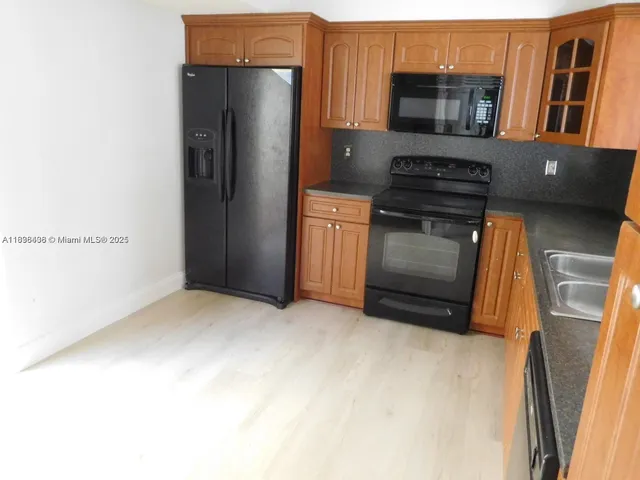 a kitchen with stainless steel appliances a refrigerator and a stove top oven