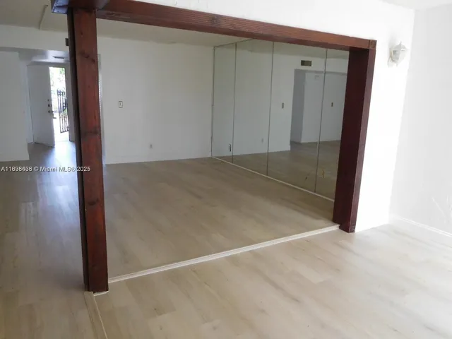 an empty room with wooden floor