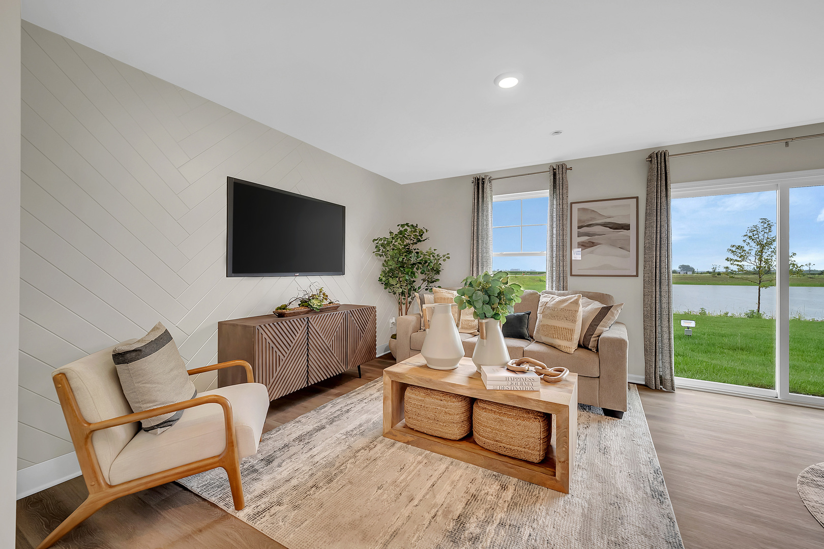 1331 Acadia Circle Pingree Grove, IL 60140 - Photo 29 of 51 a living room with furniture a flat screen tv and a floor to ceiling window