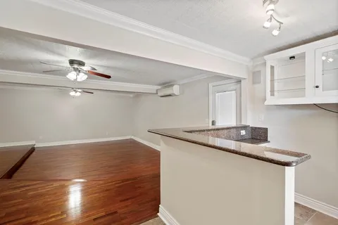 a kitchen with stainless steel appliances cabinets and a window