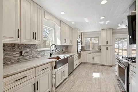 a kitchen with stainless steel appliances a stove and a refrigerator