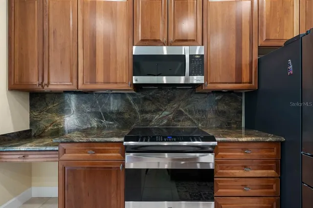 a kitchen with kitchen island a sink and a stove with wooden floor