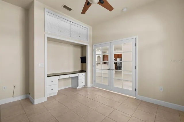 a view of an empty room with a kitchen