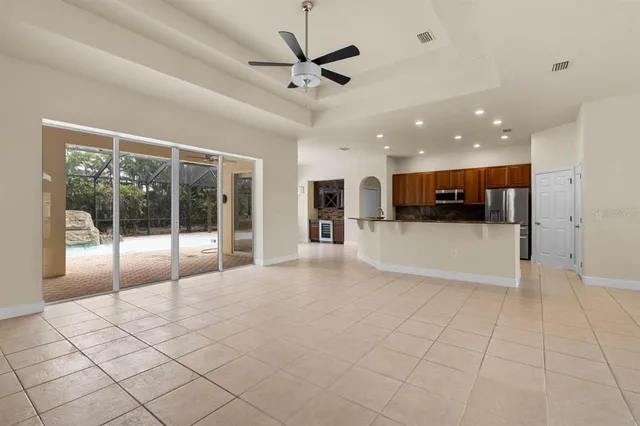 a view of a kitchen with a sink and a chandelier fan