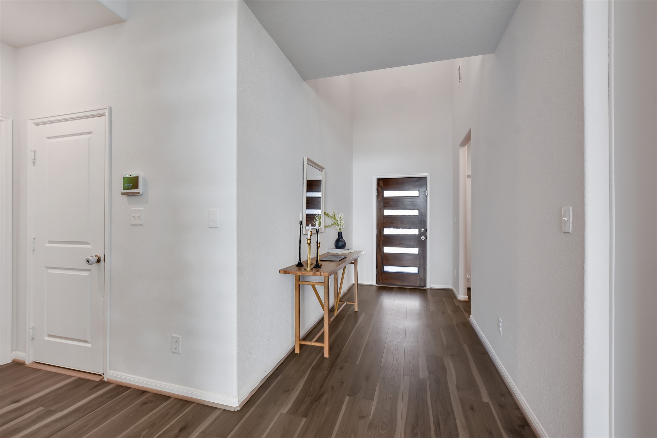 605 Oleander Loop Buda, TX 78610 - Photo 3 of 32 a view of a hallway with wooden floor and closet