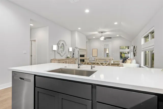 a kitchen with kitchen island a sink appliances and cabinets