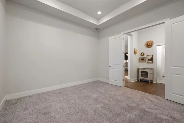 an empty room with a fireplace and a window