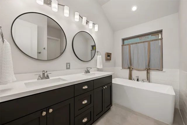 a bathroom with a double vanity sink and a mirror