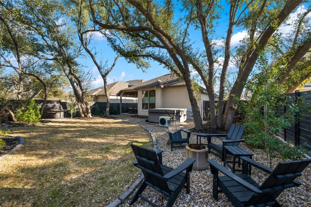 a view of a house with backyard and sitting area