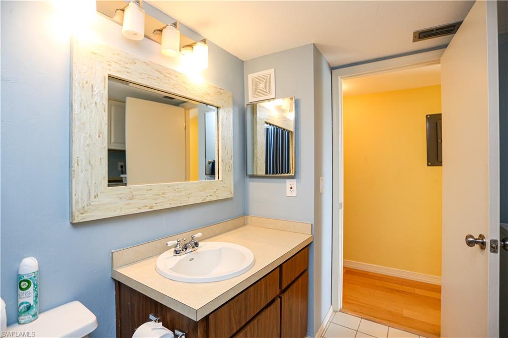 1075 Foxfire Lane, Unit 207 Naples, FL 34104 - Photo 16 of 26 a bathroom with a sink and a mirror