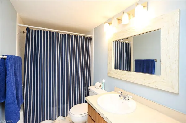 a bathroom with a sink a toilet and mirror