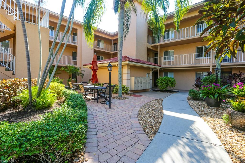 1075 Foxfire Lane, Unit 207 Naples, FL 34104 - Photo 21 of 26 a view of a building with potted plants