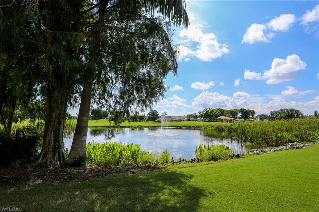 1075 Foxfire Lane, Unit 207 Naples, FL 34104 - Photo 23 of 26 a view of a lake with a big yard