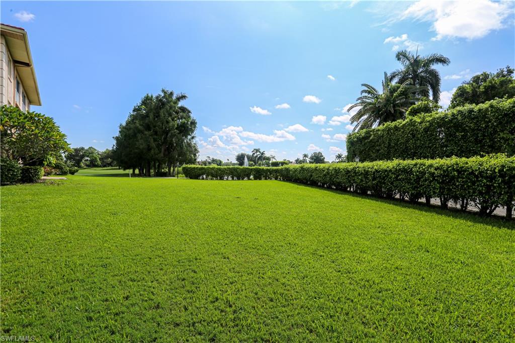 1075 Foxfire Lane, Unit 207 Naples, FL 34104 - Photo 24 of 26 a view of a golf course with a garden