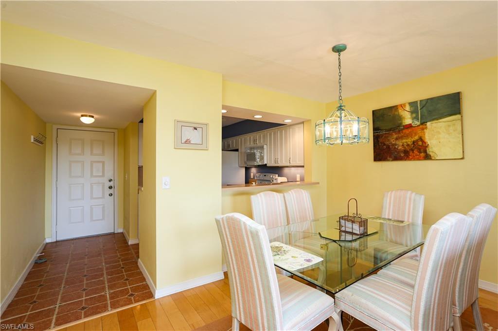 1075 Foxfire Lane, Unit 207 Naples, FL 34104 - Photo 4 of 26 a view of a dining room with furniture
