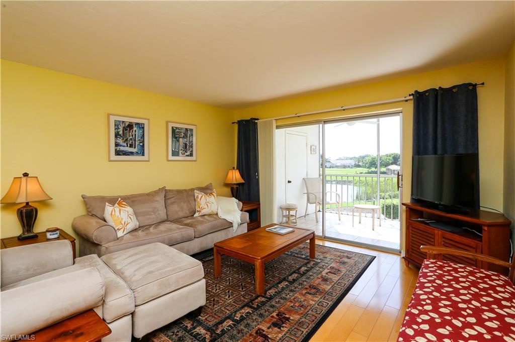 1075 Foxfire Lane, Unit 207 Naples, FL 34104 - Photo 8 of 26 a living room with furniture and a flat screen tv