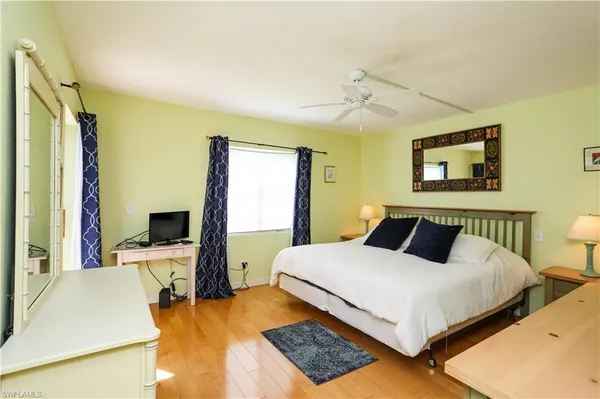 a bedroom with a bed and a desk