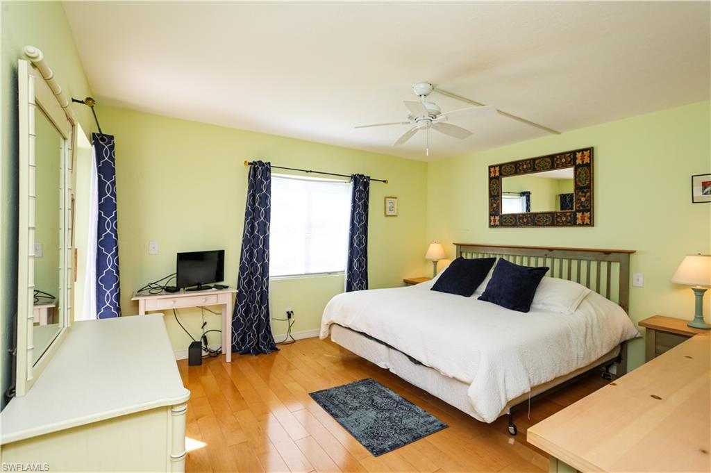 1075 Foxfire Lane, Unit 207 Naples, FL 34104 - Photo 9 of 26 a bedroom with a bed and a desk