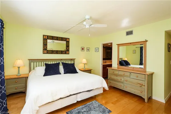 a bedroom with a bed and a painting on the wall