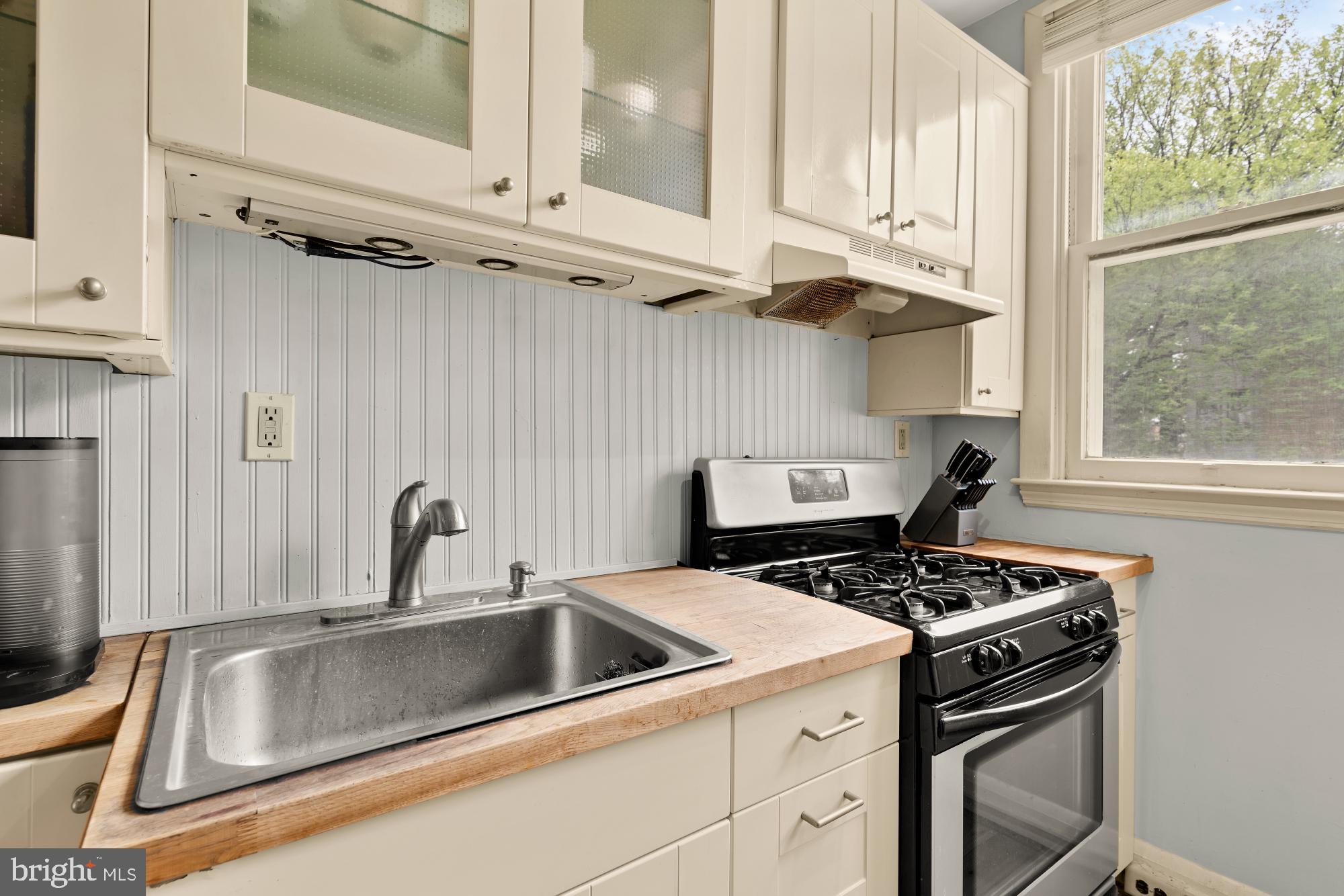 159 West Lanvale Street, Unit 5 Baltimore, MD 21201 - Photo 15 of 34 a kitchen with stainless steel appliances a sink a stove and a refrigerator