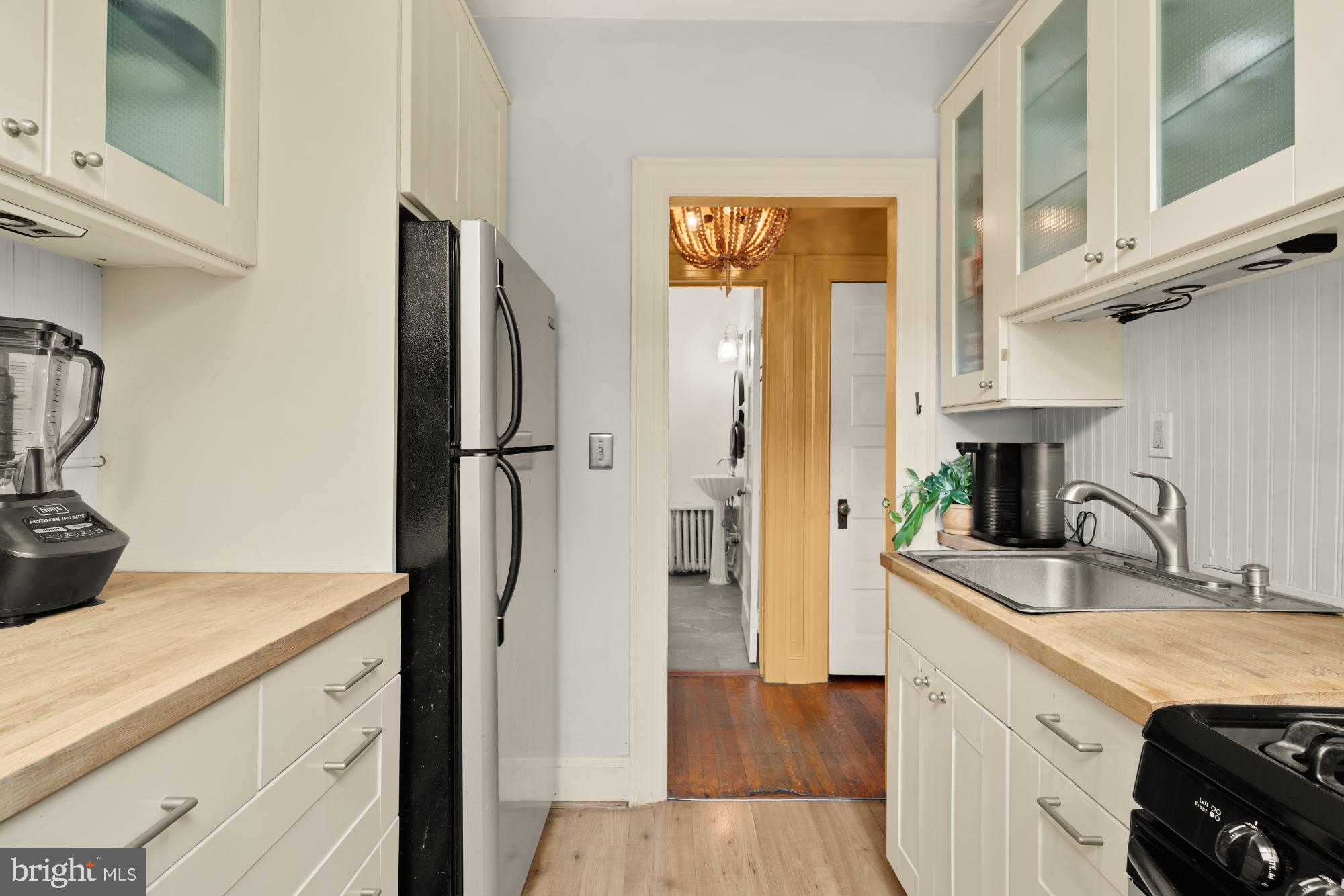 159 West Lanvale Street, Unit 5 Baltimore, MD 21201 - Photo 16 of 34 a kitchen with stainless steel appliances granite countertop a refrigerator and a sink