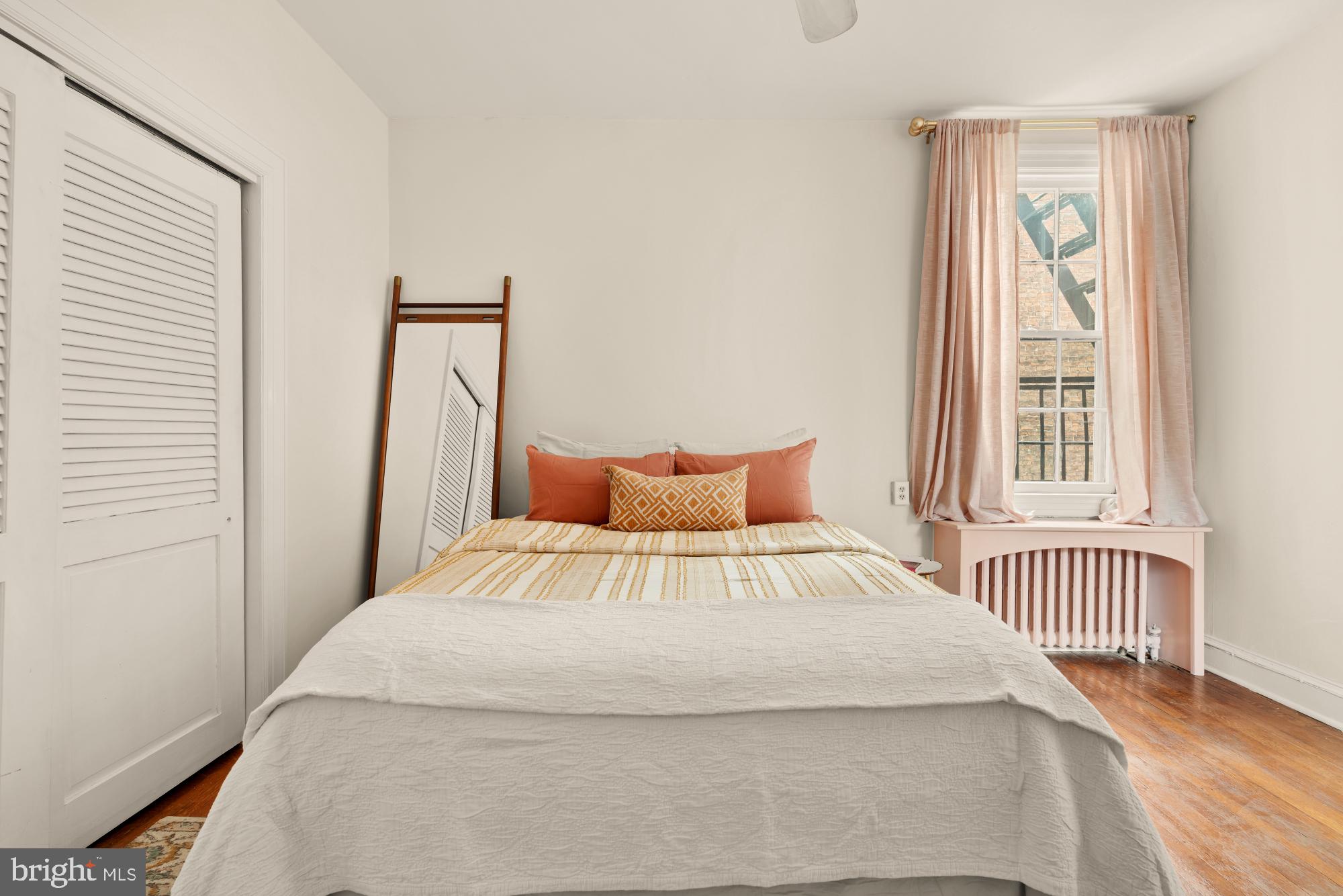 159 West Lanvale Street, Unit 5 Baltimore, MD 21201 - Photo 17 of 34 a bedroom with a bed and a window