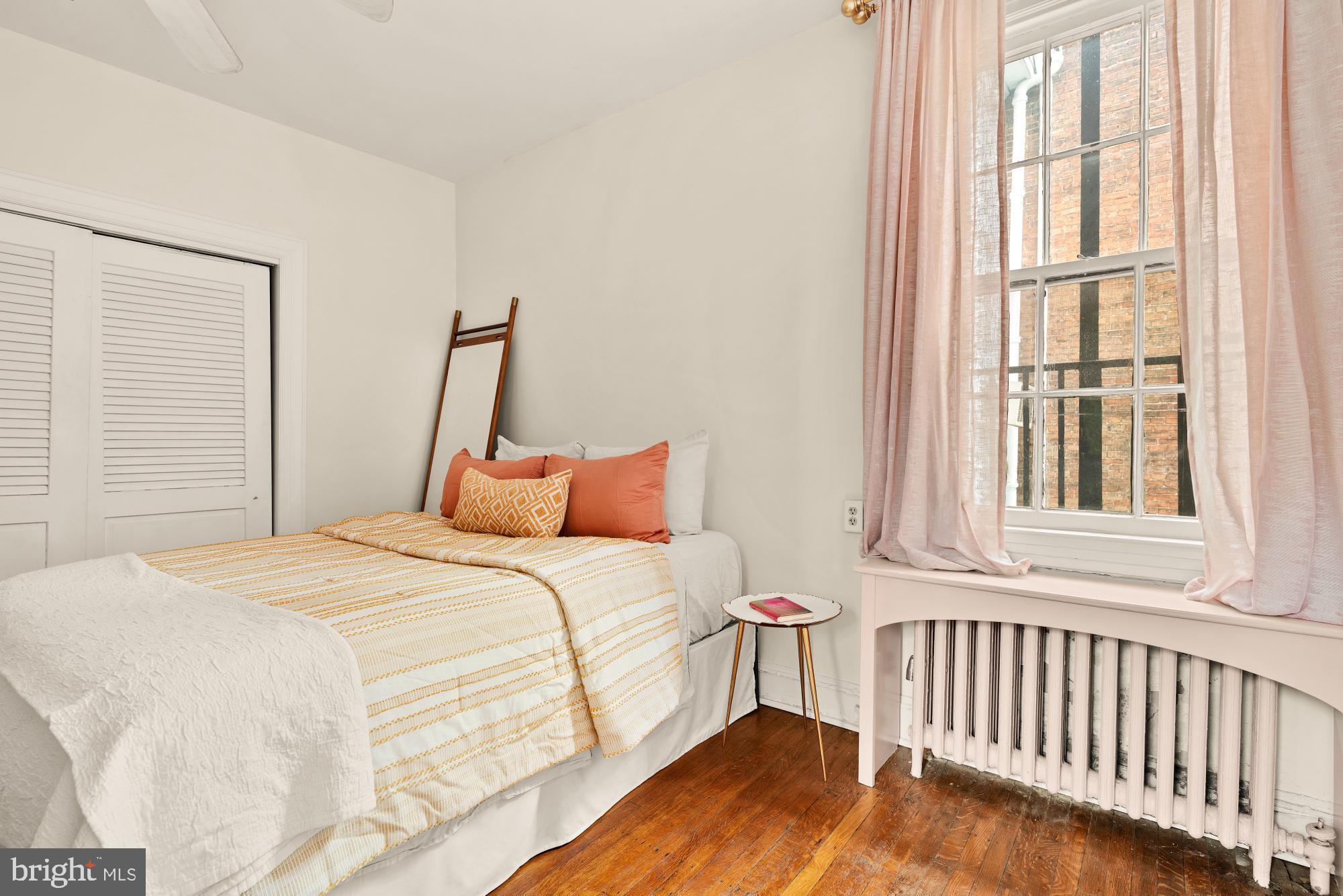 159 West Lanvale Street, Unit 5 Baltimore, MD 21201 - Photo 18 of 34 a bedroom with a bed and a window