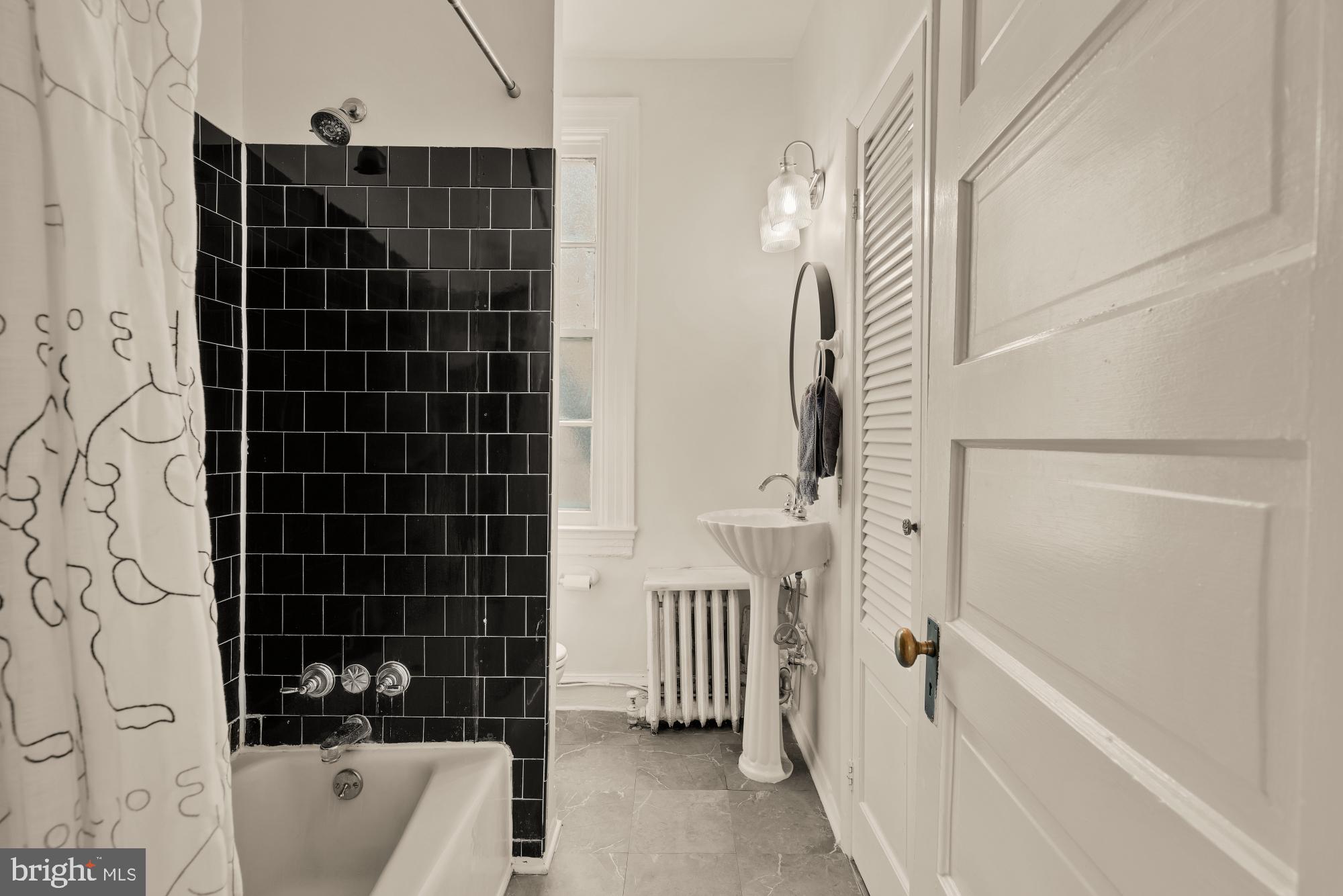 159 West Lanvale Street, Unit 5 Baltimore, MD 21201 - Photo 21 of 34 a bathroom with a bathtub and shower