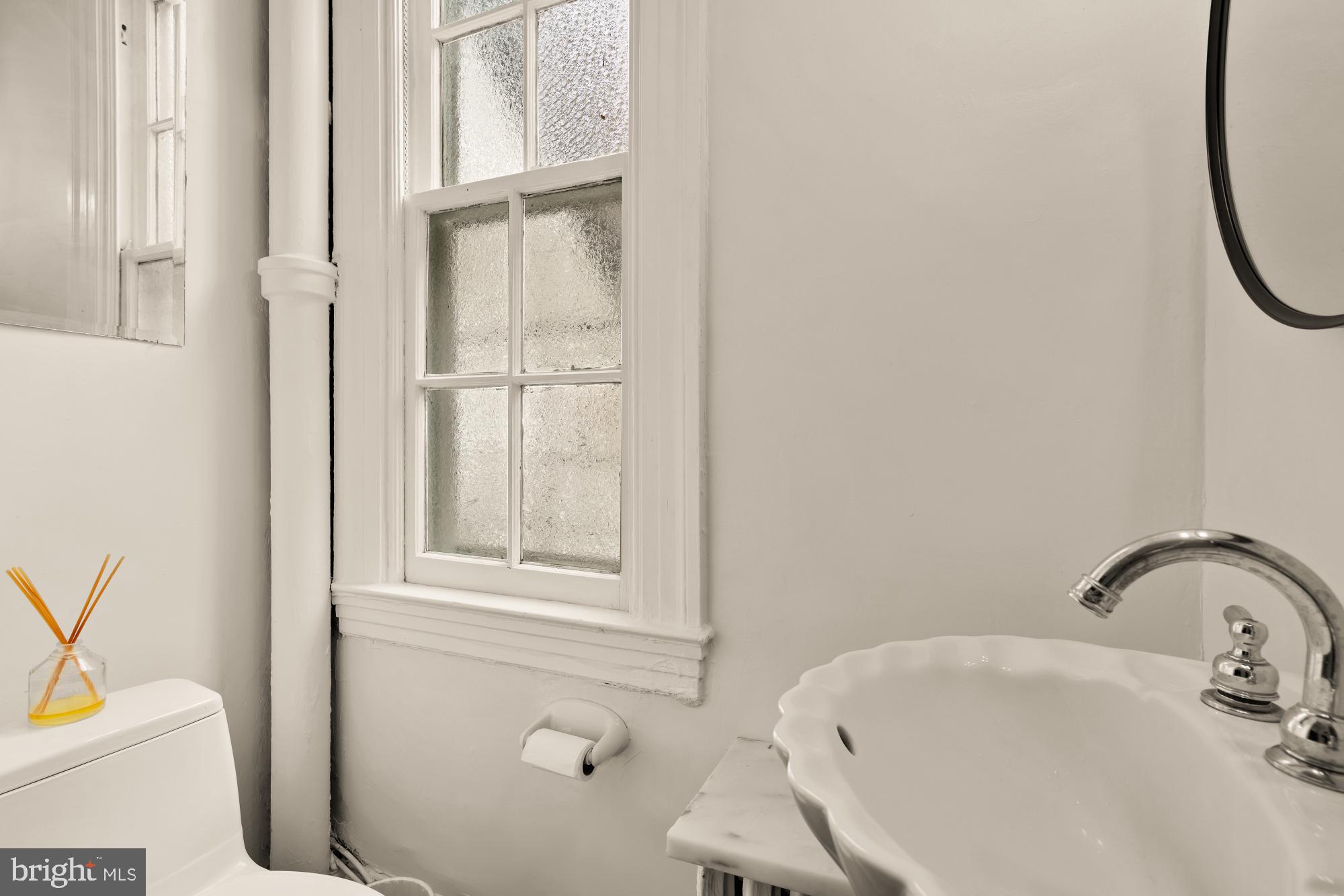 159 West Lanvale Street, Unit 5 Baltimore, MD 21201 - Photo 22 of 34 a bathroom with a sink and a toilet