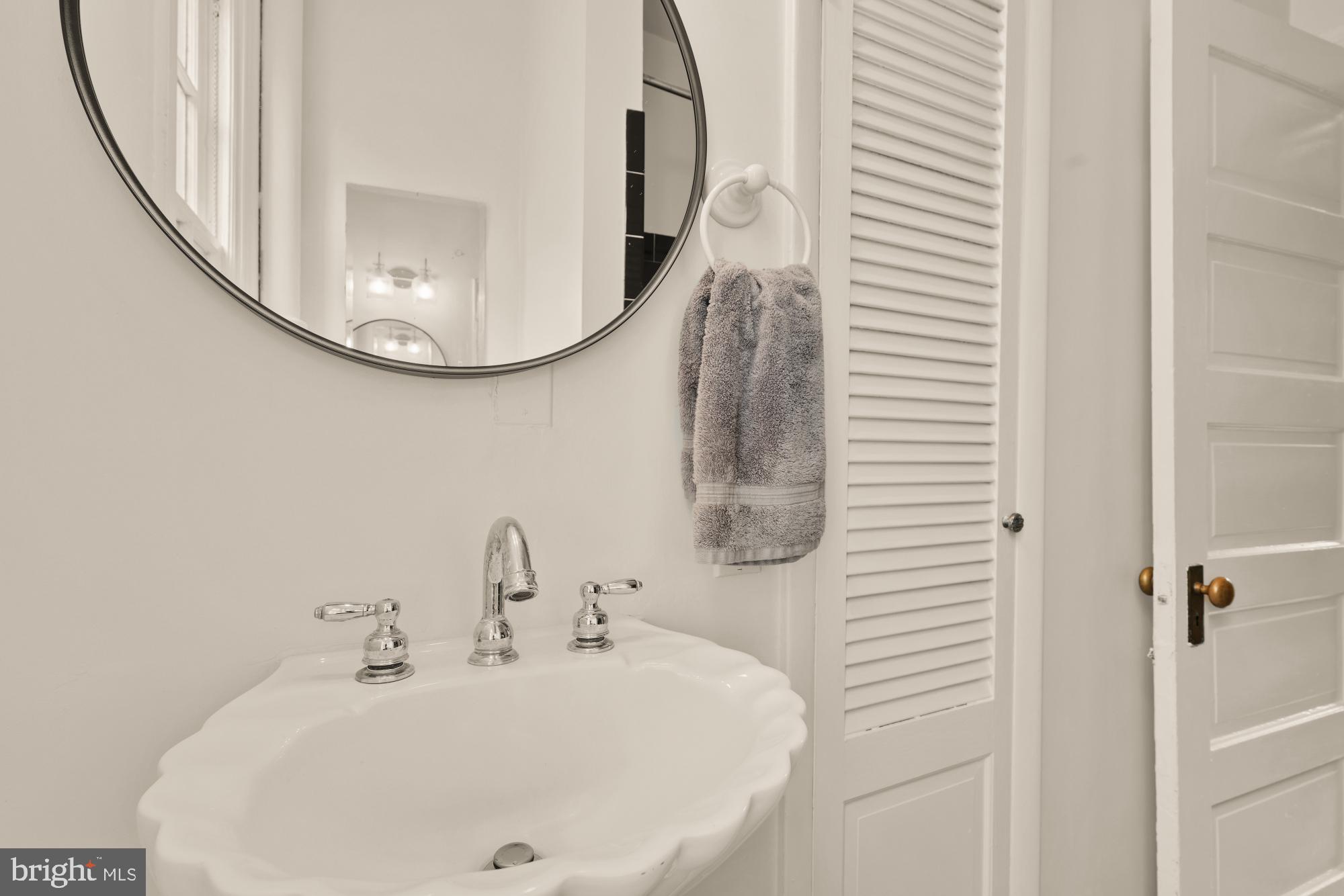 159 West Lanvale Street, Unit 5 Baltimore, MD 21201 - Photo 23 of 34 a bathroom with a sink and a mirror