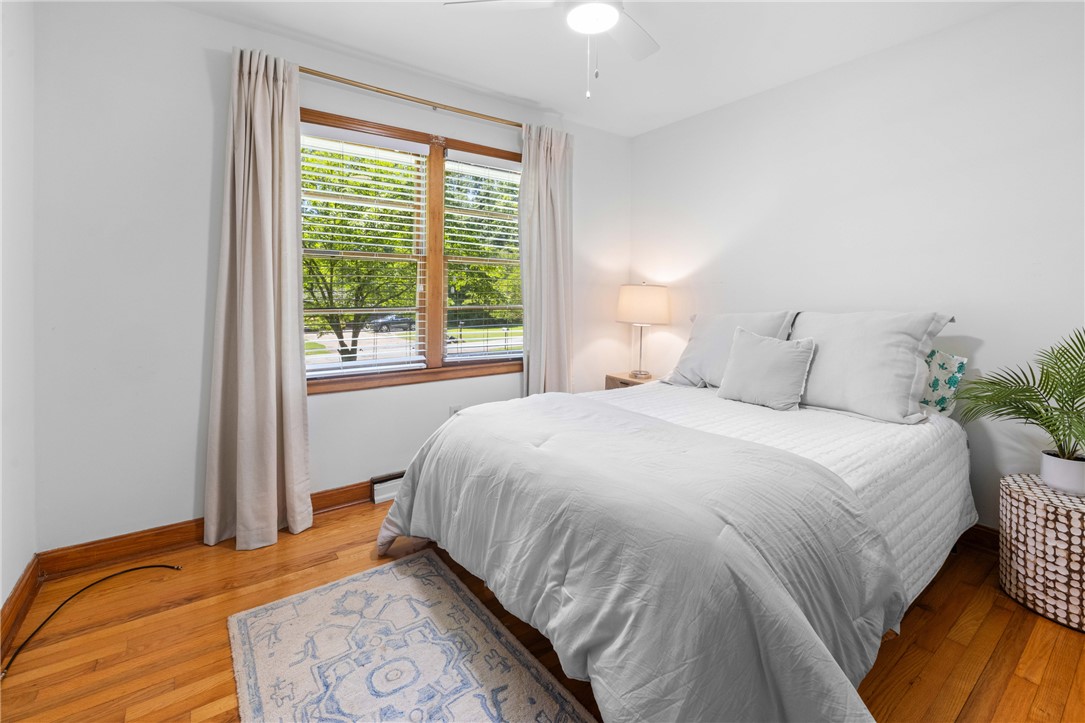 207 Brook Street Clemson, SC 29631 - Photo 17 of 39 Warm hardwood floors and a spacious window create a comfortable and inviting atmosphere in this bedroom.