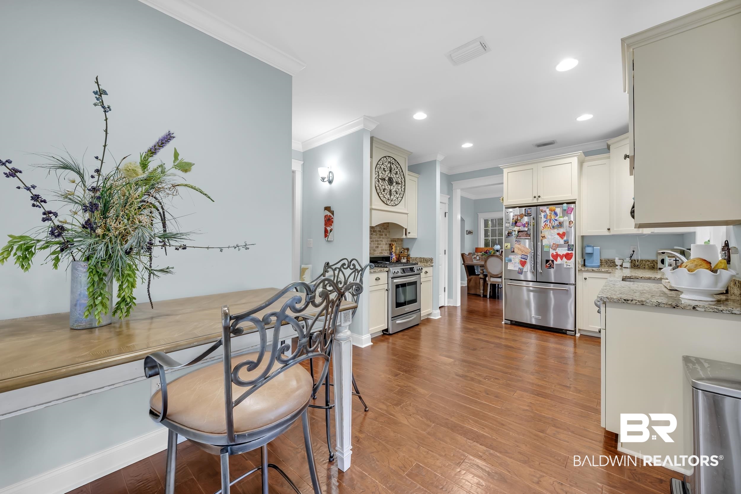 7 Bienville Avenue Mobile, AL 36606 - Photo 13 of 32 Kitchen featuring light stone counters, stainless steel appliances, crown molding, light wood-style flooring, and recessed lighting