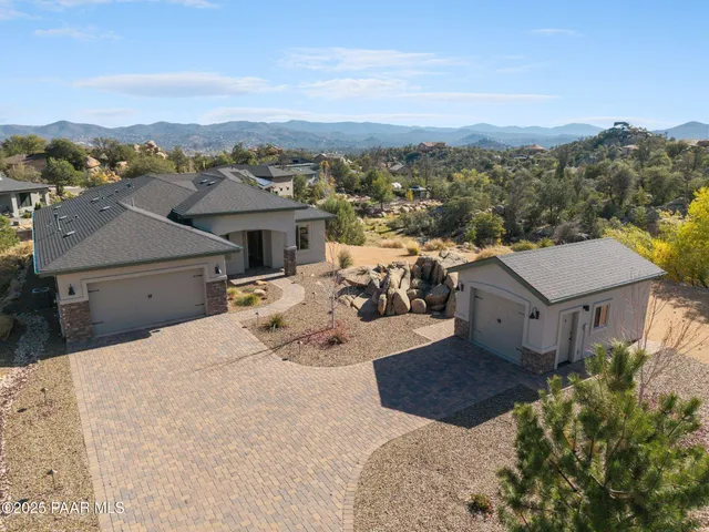 an aerial view of a house with a mountain view