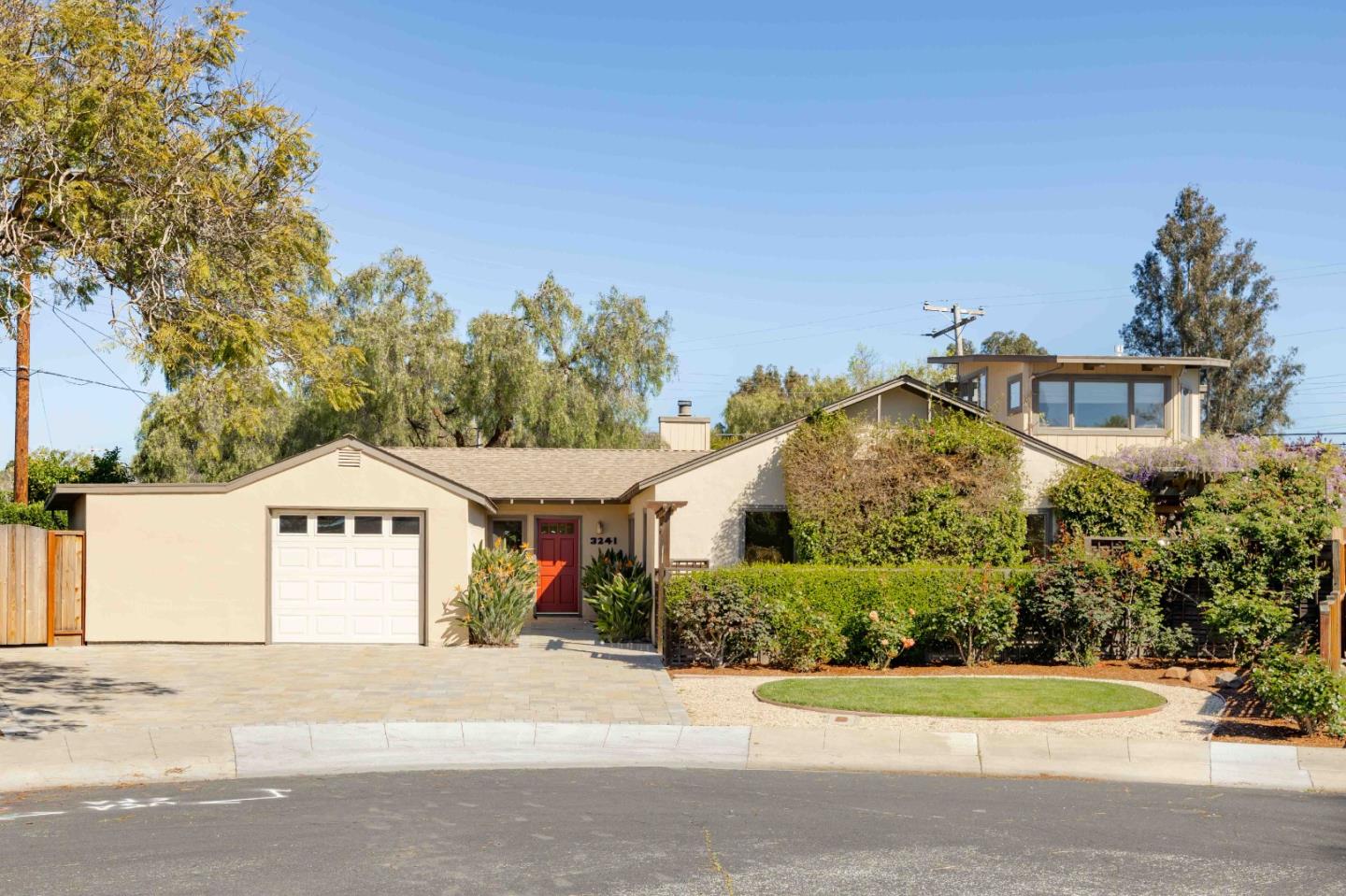 3241 Greer Road Palo Alto, CA 94303 - Photo 2 of 26 a front view of a house with a garden