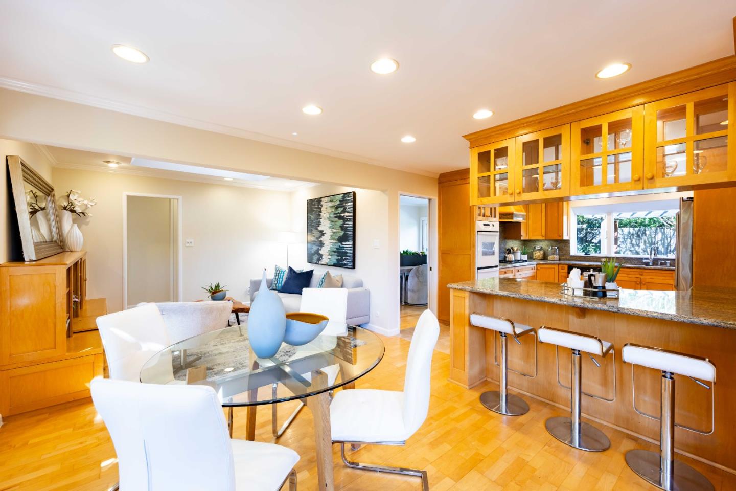 3241 Greer Road Palo Alto, CA 94303 - Photo 10 of 26 a view of a dining room with furniture a kitchen and chandelier