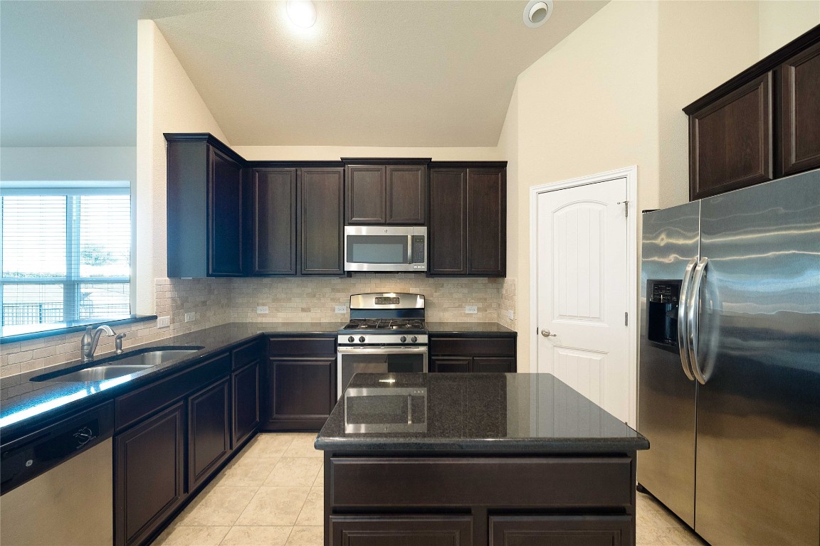 13720 Loleta Way Austin, TX 78717 - Photo 11 of 29 a kitchen with a sink stove and refrigerator