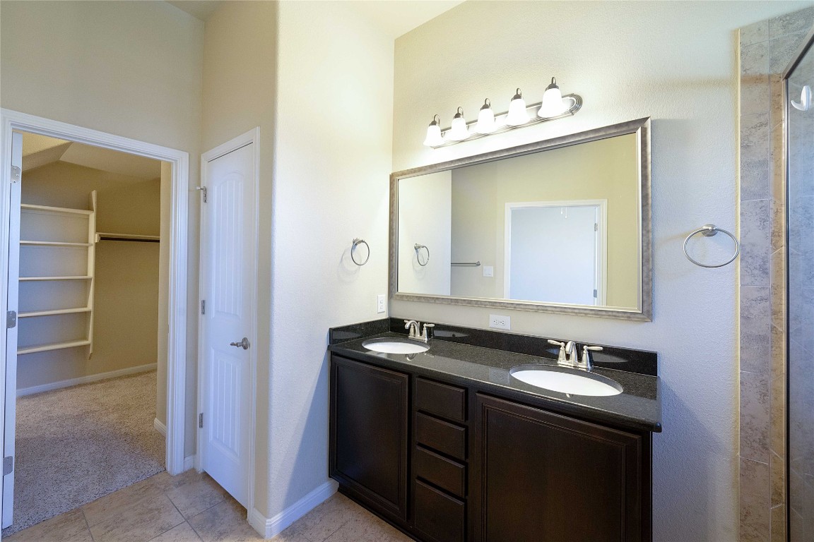 13720 Loleta Way Austin, TX 78717 - Photo 19 of 29 a bathroom with a sink vanity and mirror