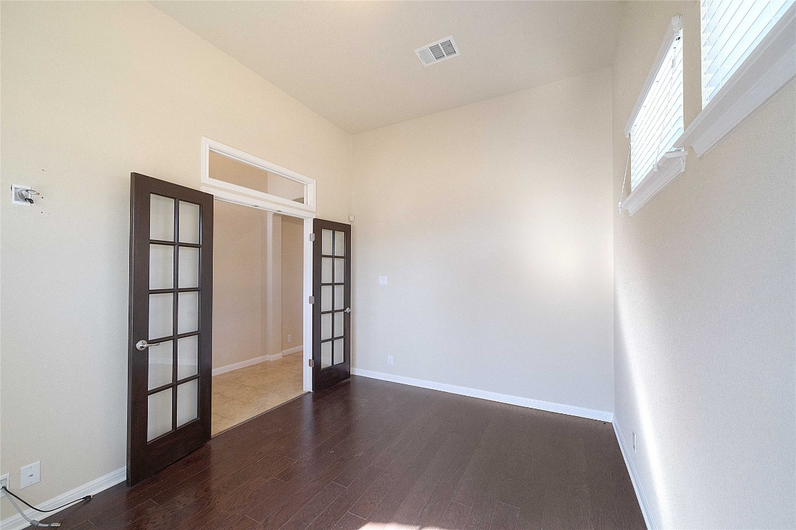 13720 Loleta Way Austin, TX 78717 - Photo 9 of 29 an empty room with wooden floor and windows