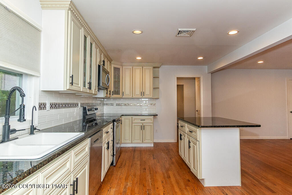755 White Oak Road Cresco, PA 18326 - Photo 8 of 50 a kitchen with stainless steel appliances granite countertop a sink stove and refrigerator
