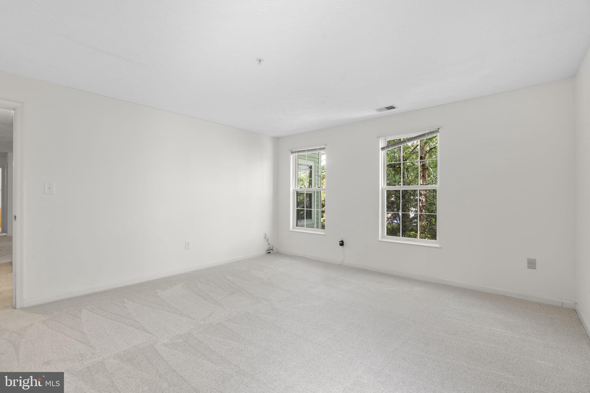 2444 Blue Spring Court, Unit 203 Odenton, MD 21113 - Photo 19 of 36 an empty room with windows