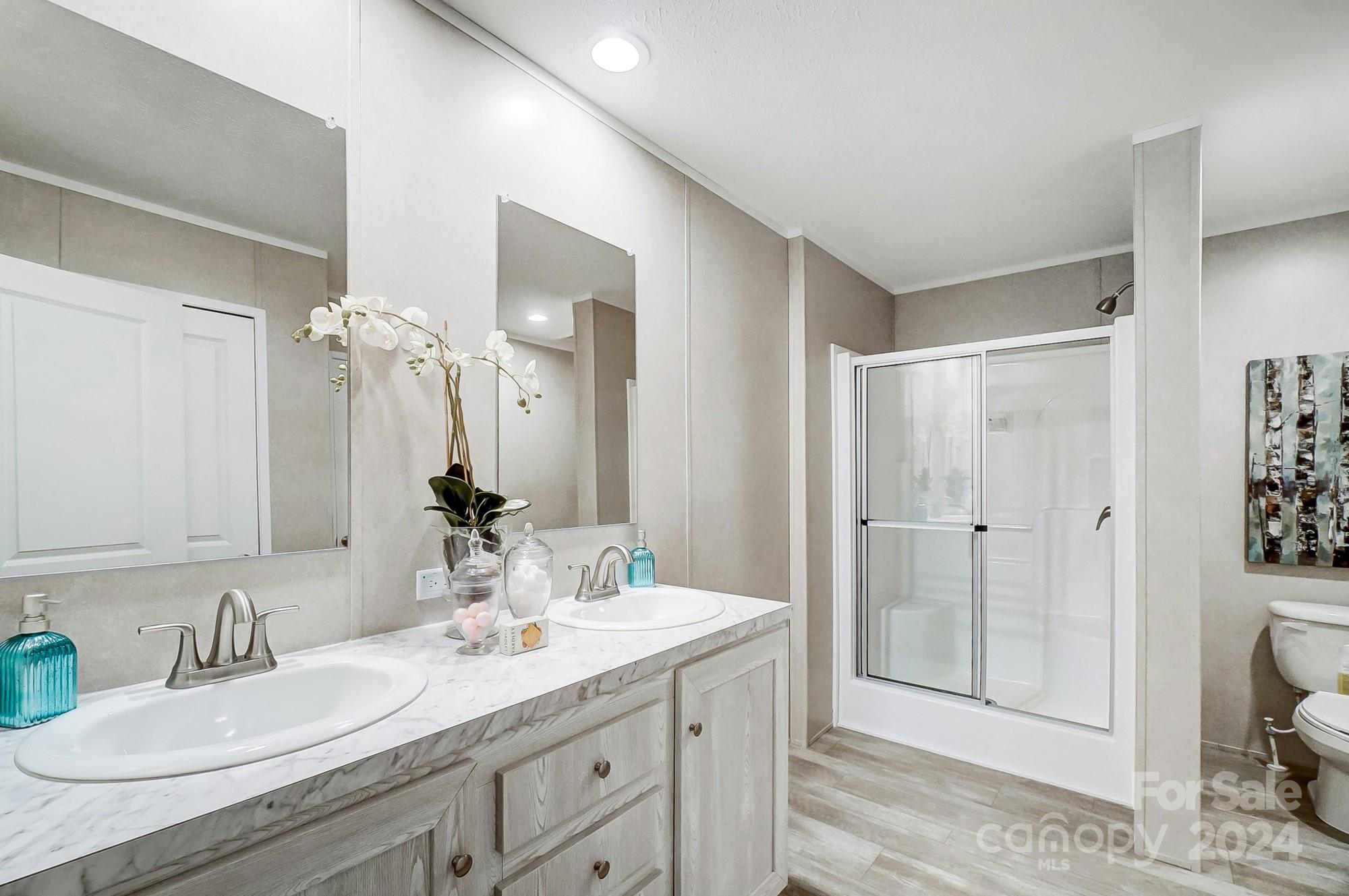 1860 Bascom Lane Midland, NC 28107 - Photo 13 of 27 a bathroom with a granite countertop sink a toilet and shower