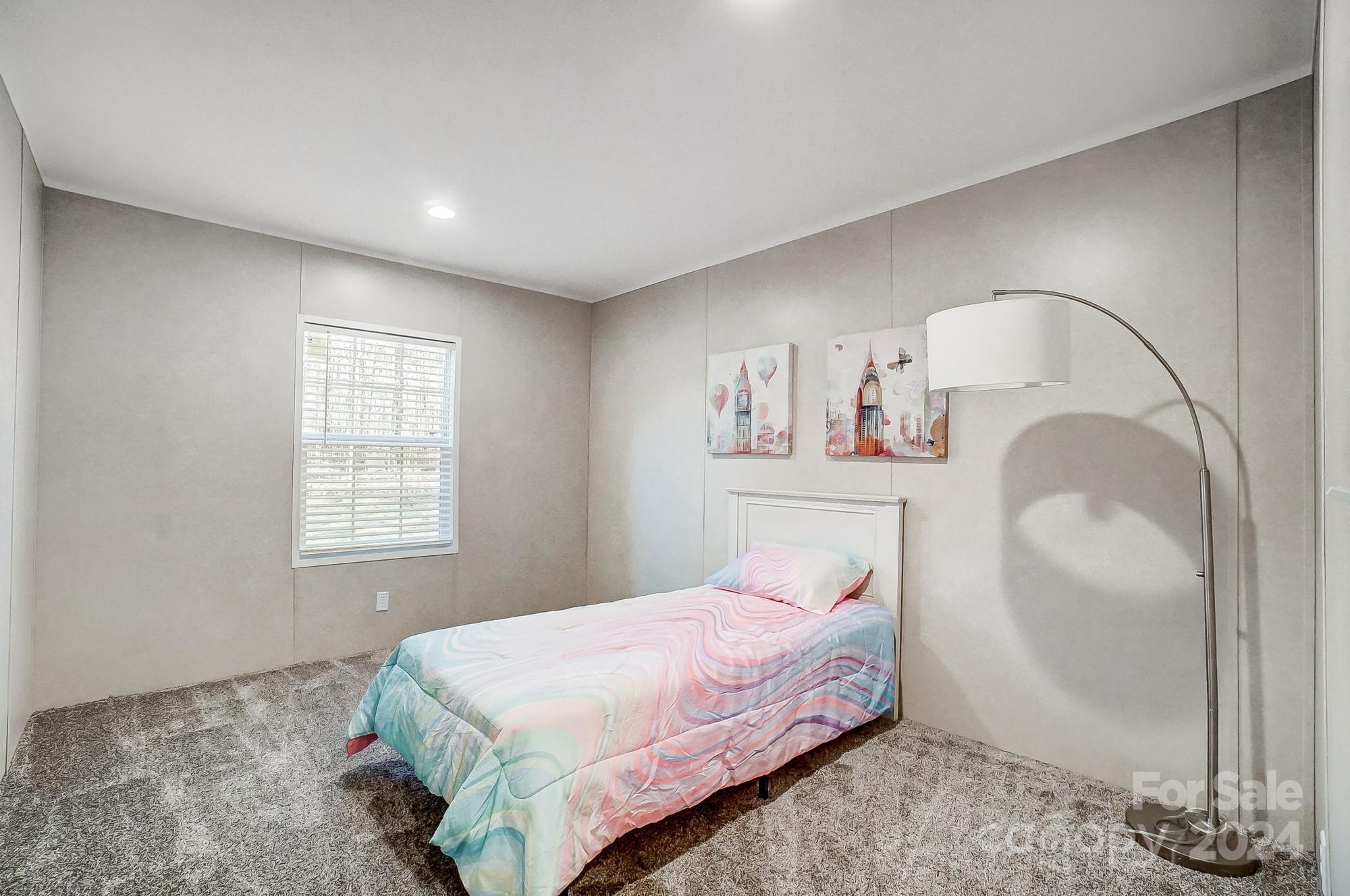 1860 Bascom Lane Midland, NC 28107 - Photo 18 of 27 a bedroom with a bed and a mirror